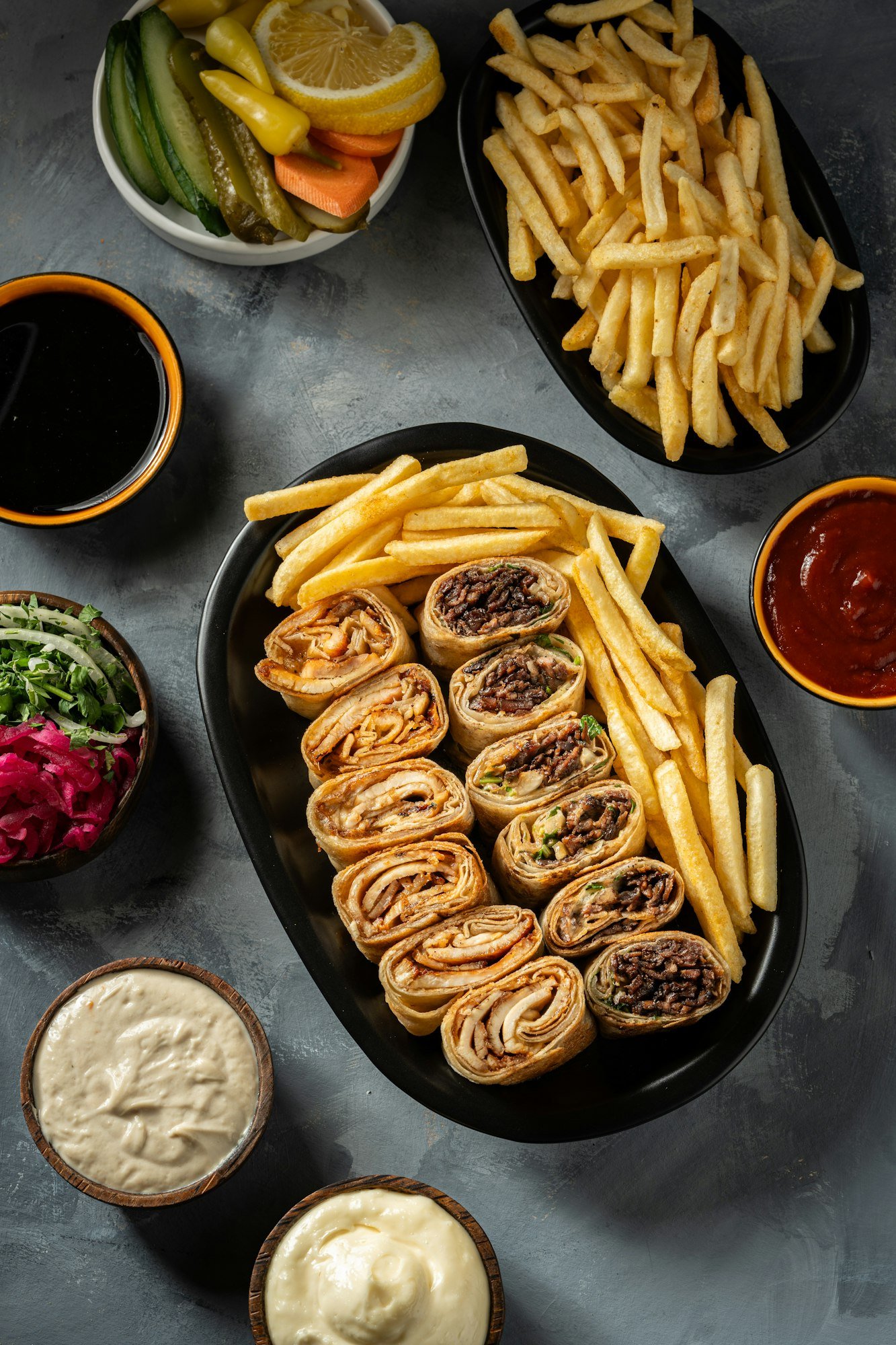 a plate of chicken and lamb shawarma with appetizers